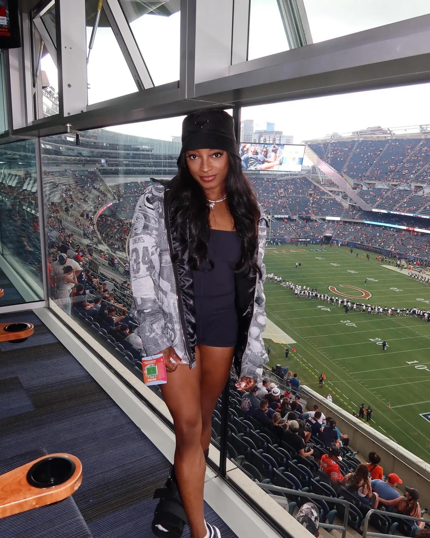 Simone Biles wearing a Packers jacket