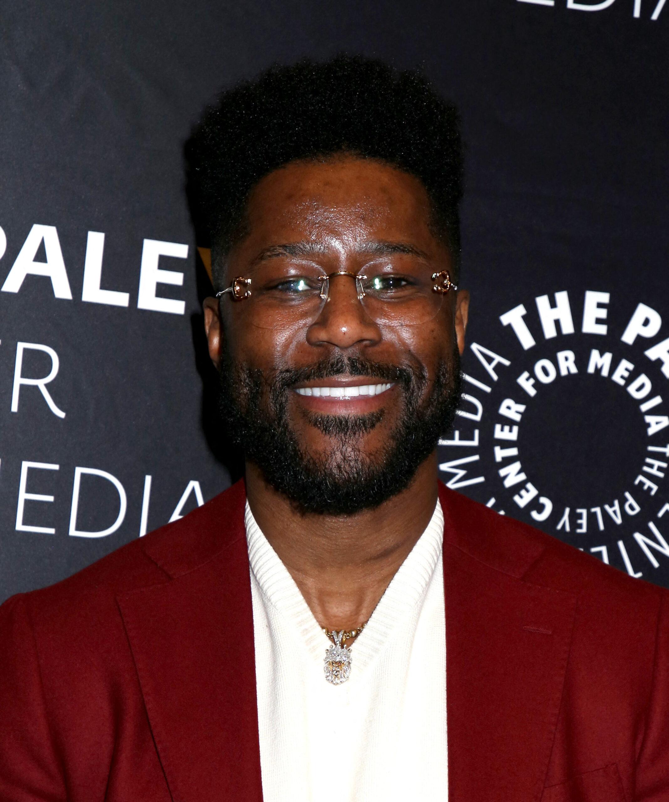 Nate Burleson wearing a maroon jacket