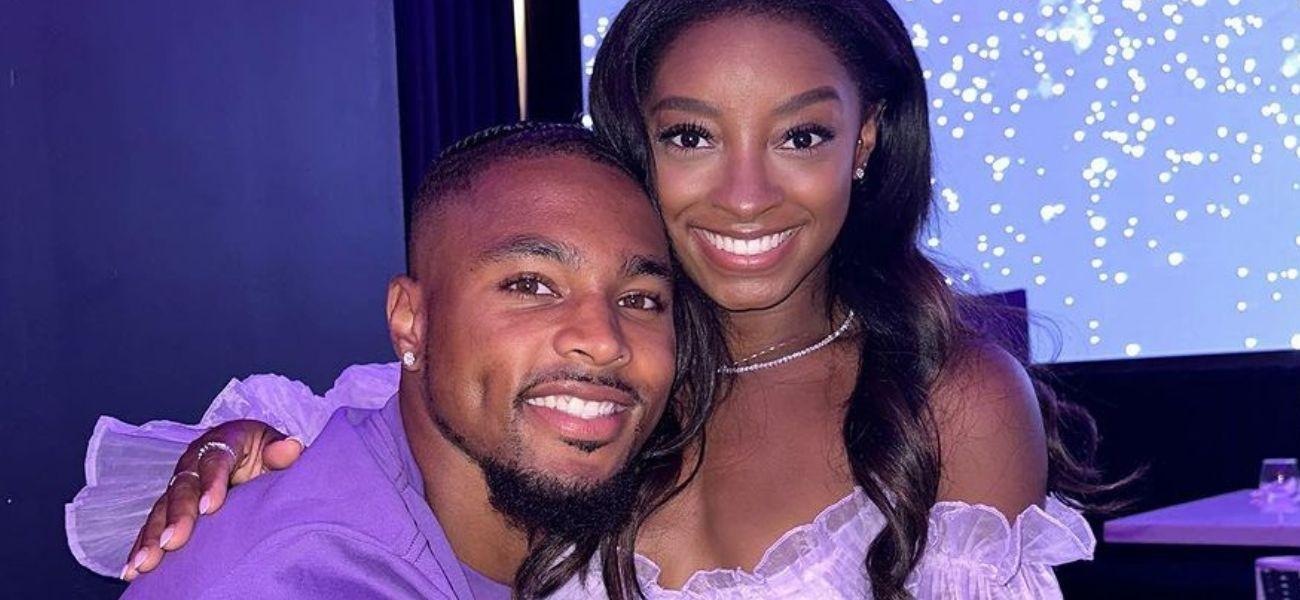 Jonathan Owens and Simone Biles matching in purple outfits