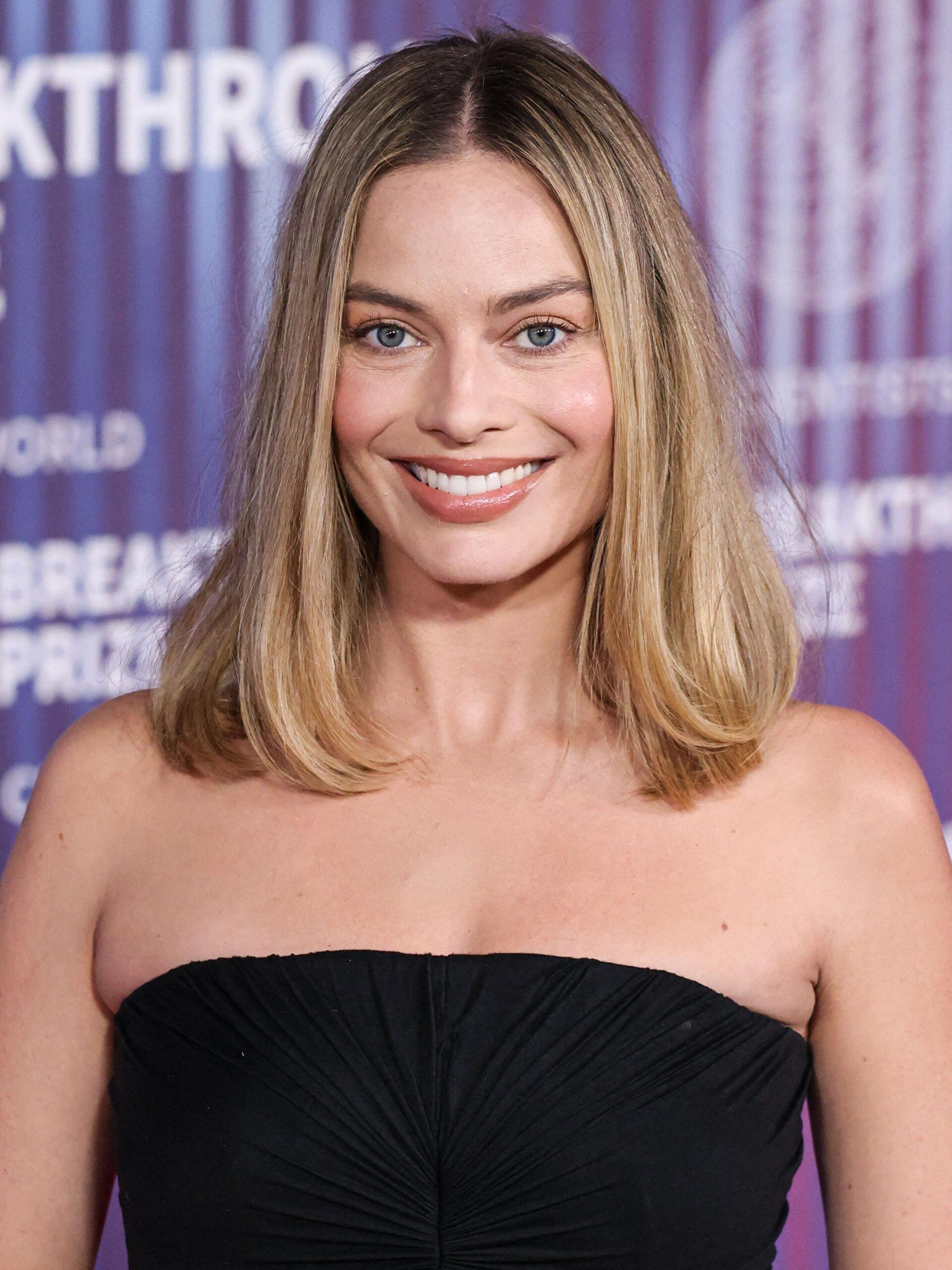 Margot Robbie smiling for an event