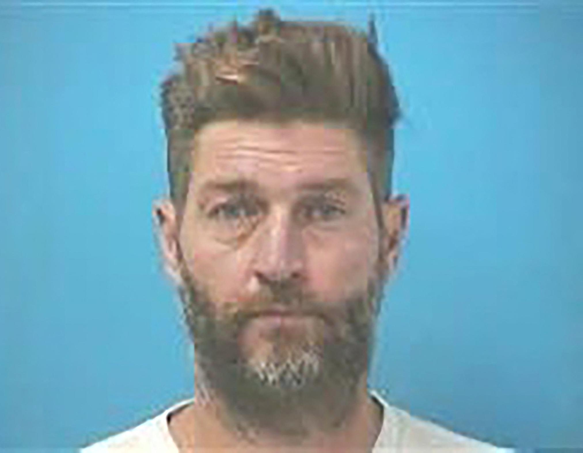 Jay Cutler poses for mugshot after being arrested for DUI and gun possession in Tennessee.