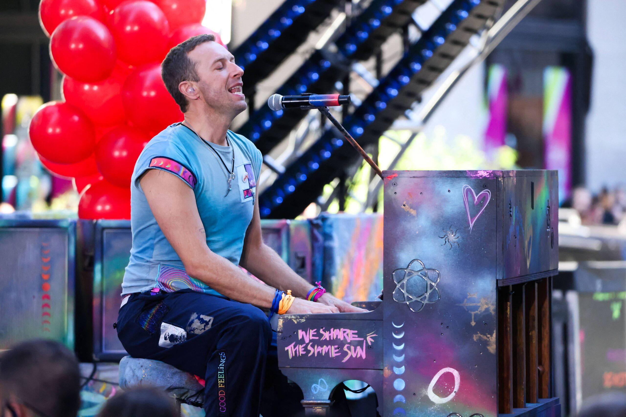 Vocalist Chris Martin along with his band Coldplay during a performance on a television show at Rockefeller Plaza in New York City