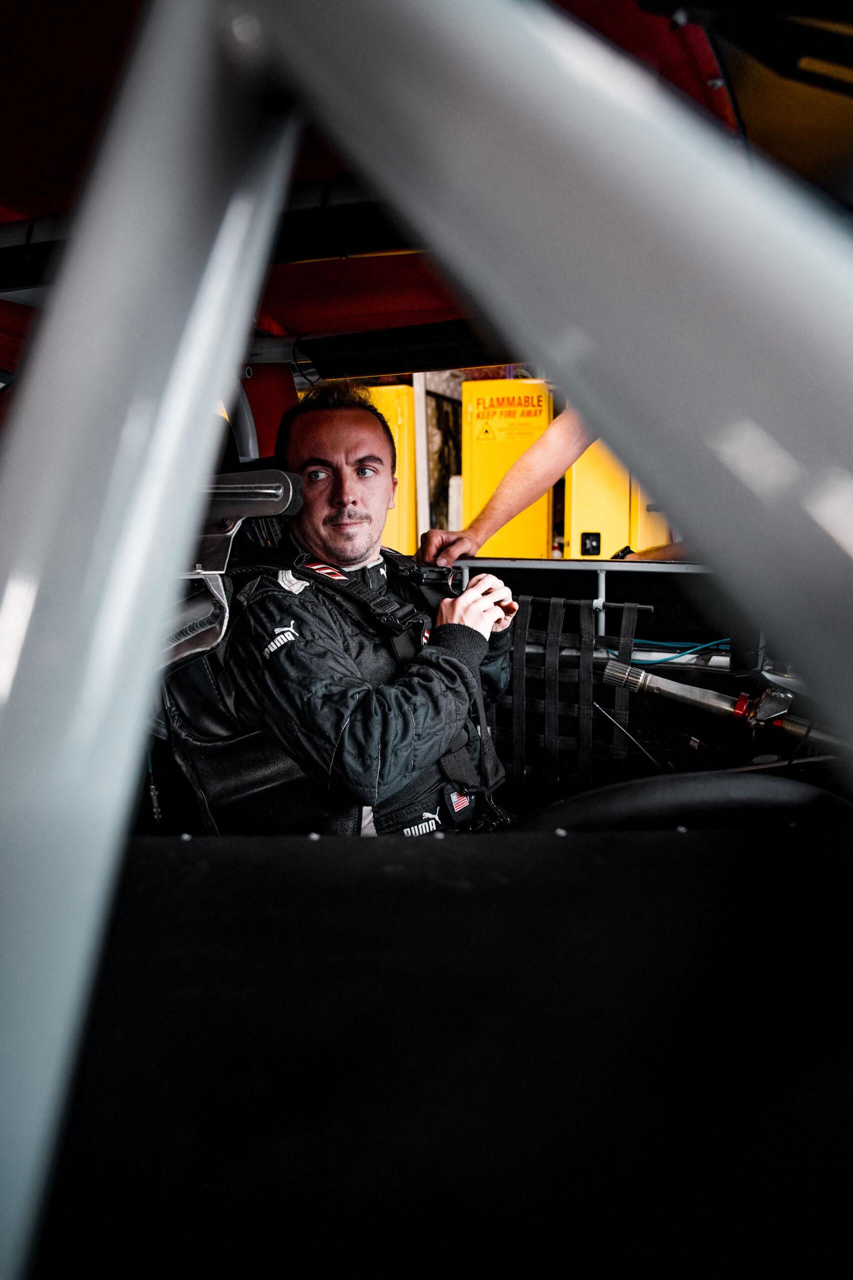 Frankie Muniz sitting in car after he becomes a full-time race car driver