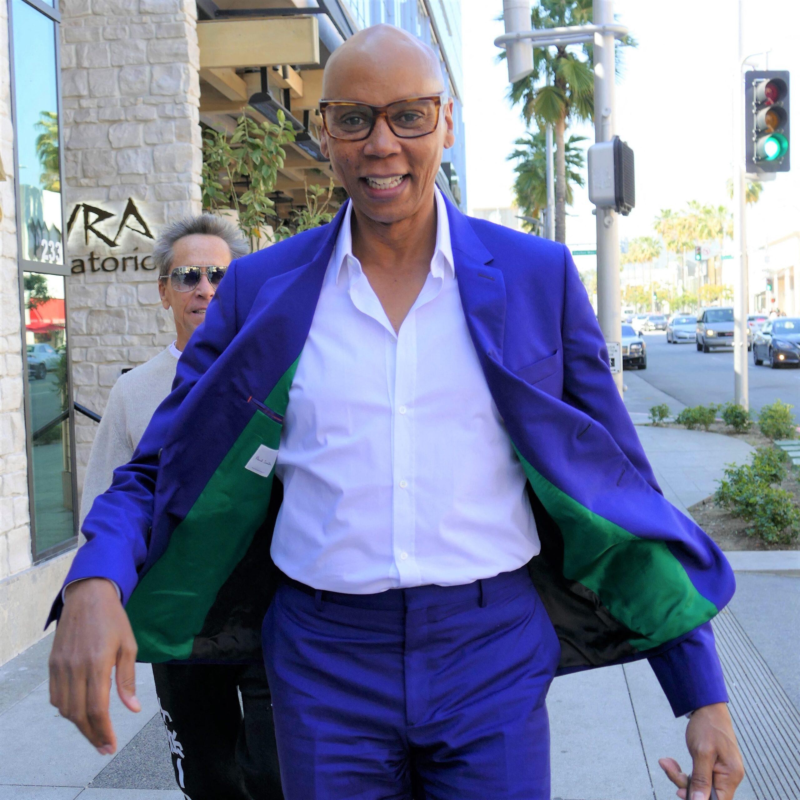 RuPaul Seen Leaving Lunch In Fashionably Blue Suit & Brown Designer Handbag