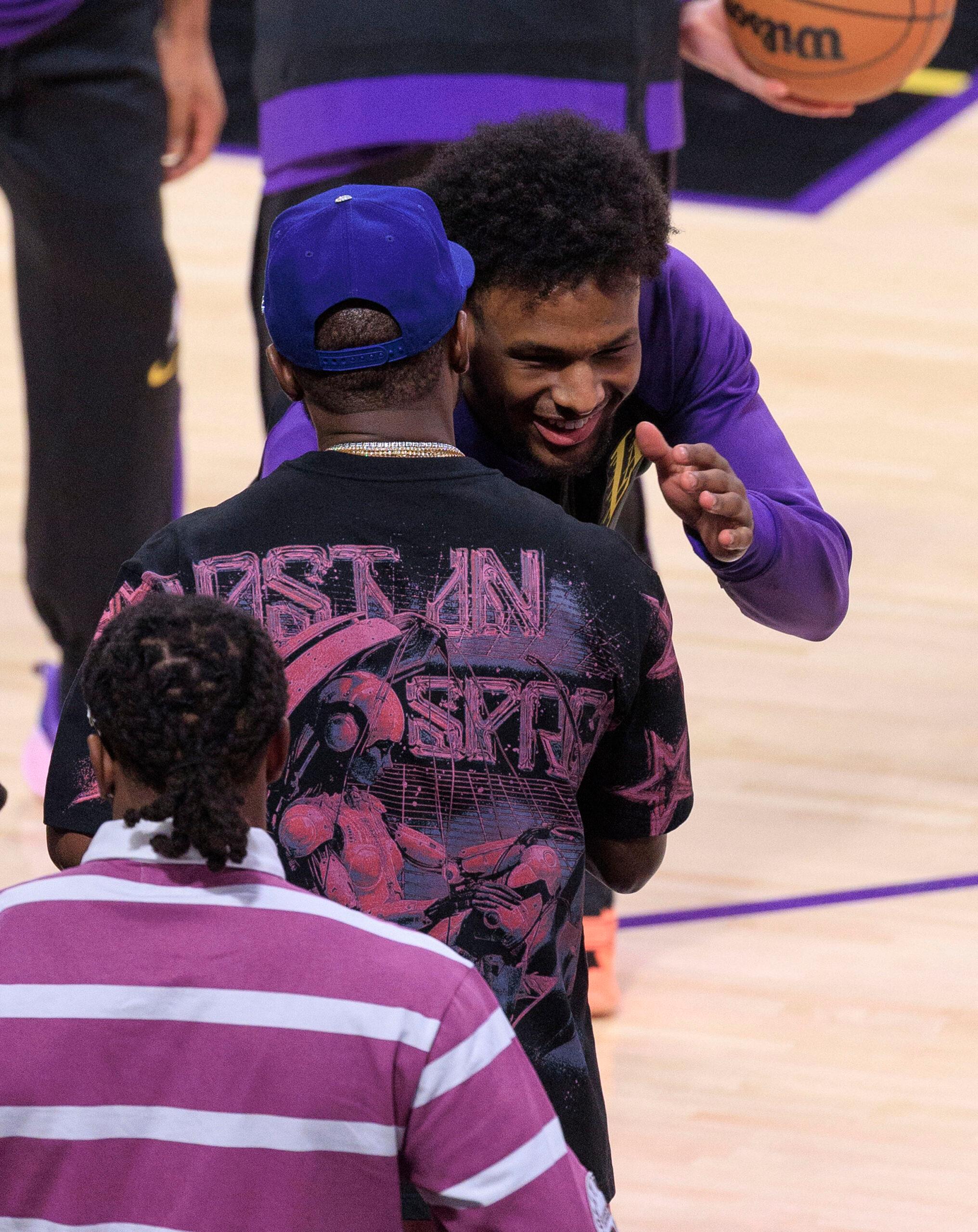 Bronny James #9 greets Floyd Mayweather Jr. 