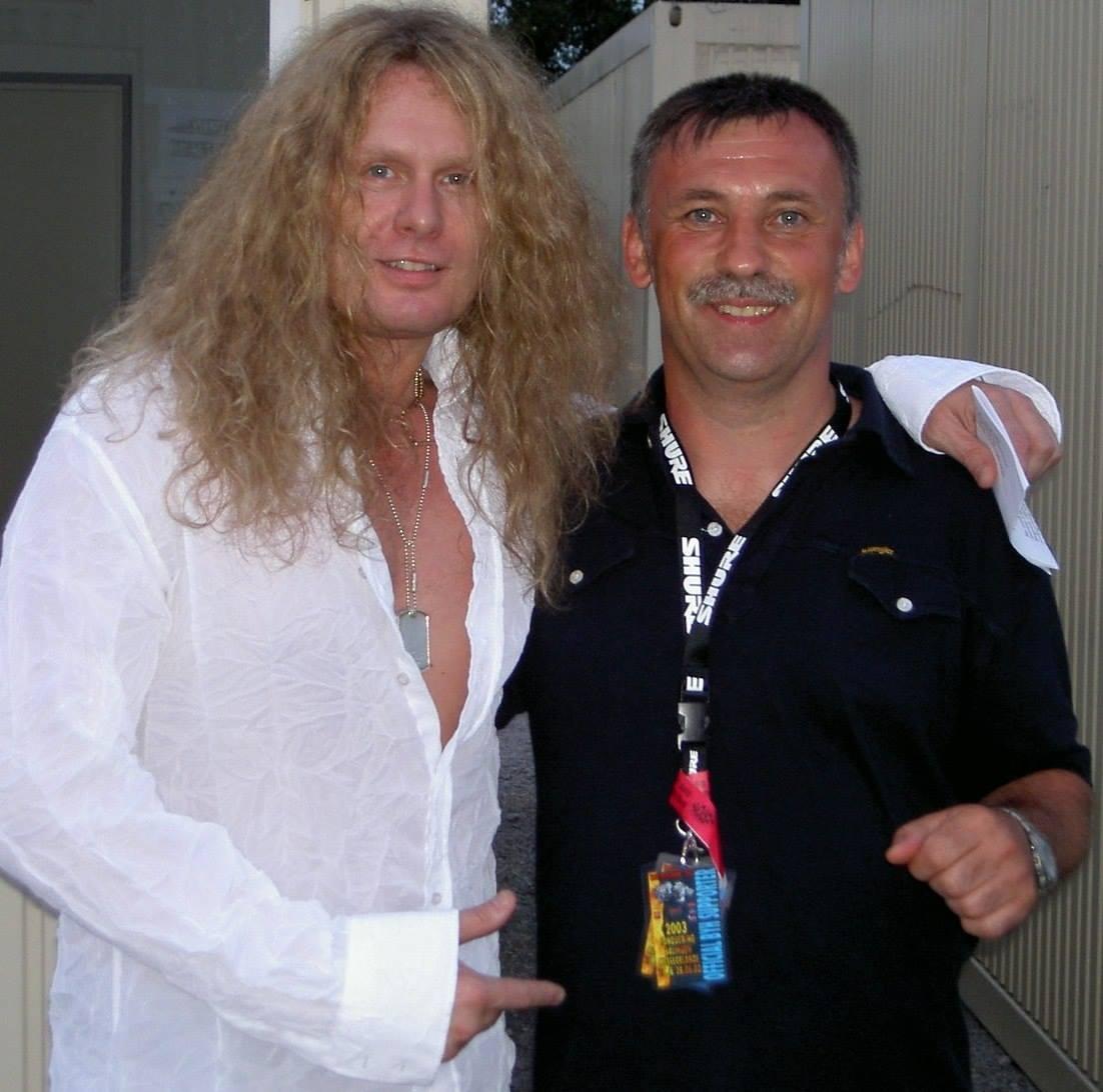 John Sykes posing with a fan