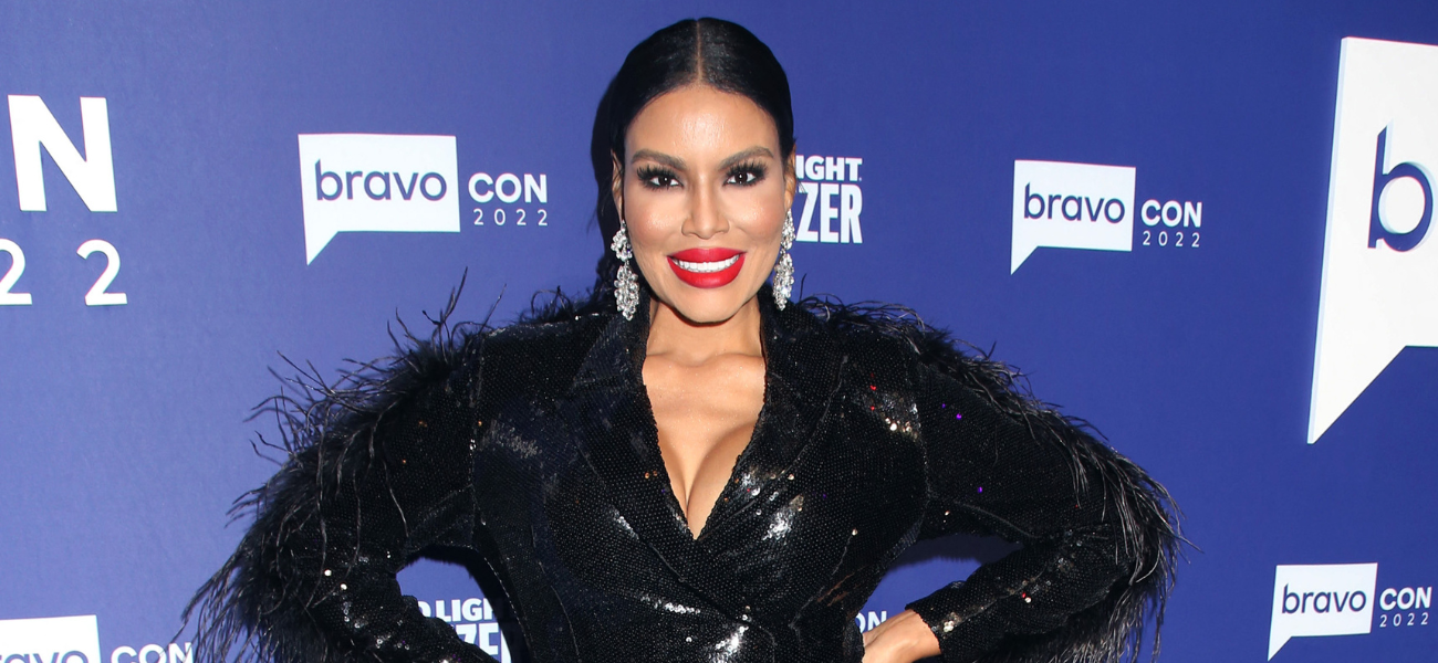 Mia Thornton posing in a black dress on the red carpet.