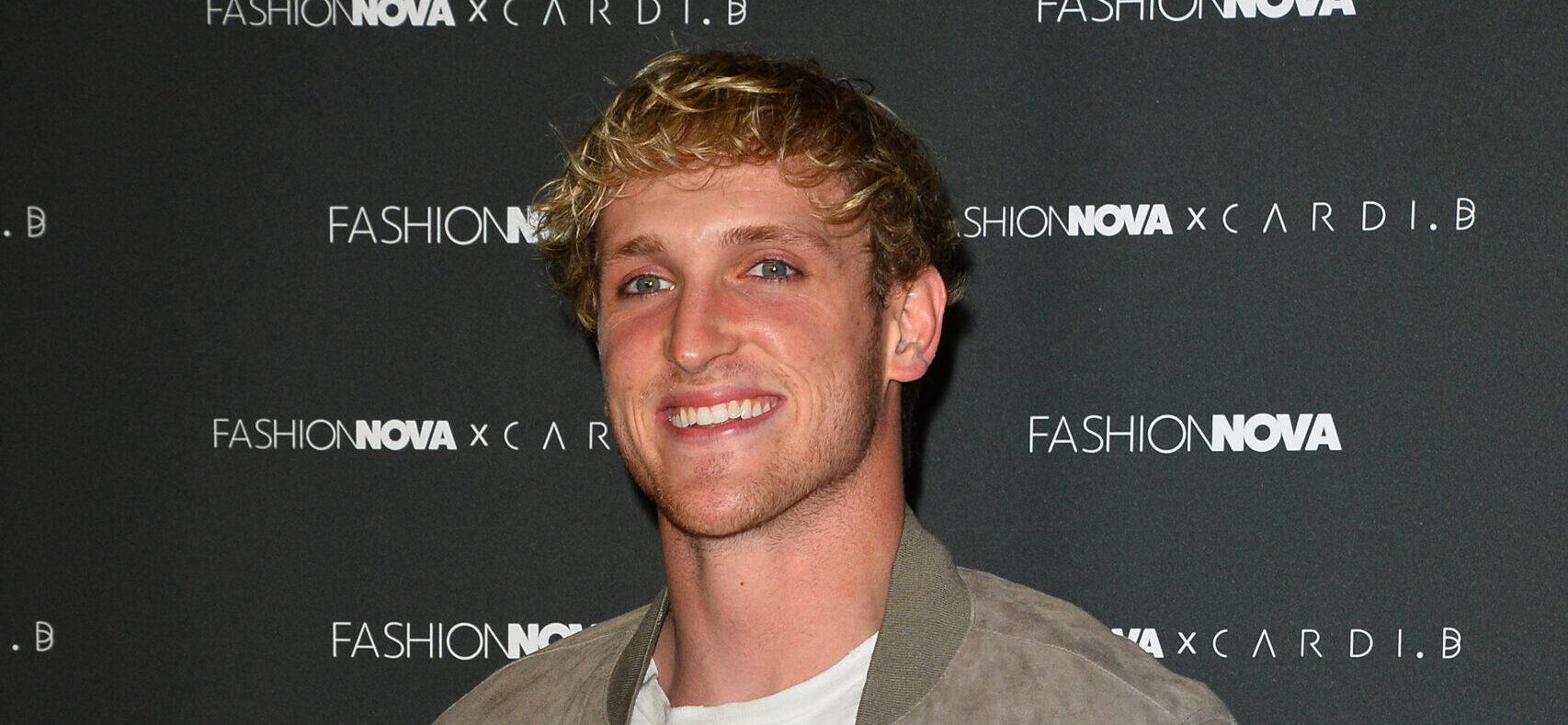 Logan Paul smiling in a green jack on the red carpet.