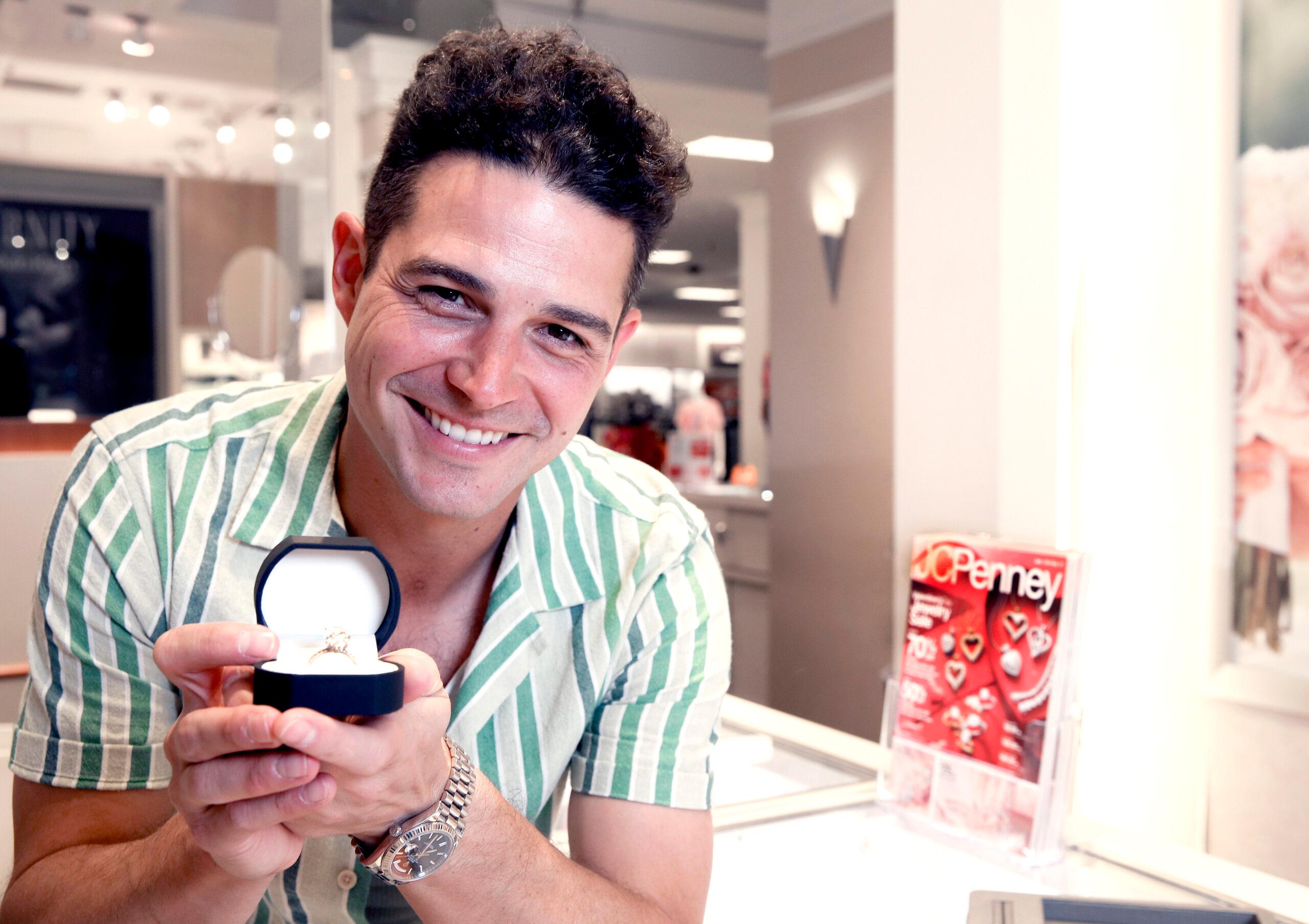 Wells Adams holding ring in JCPenney