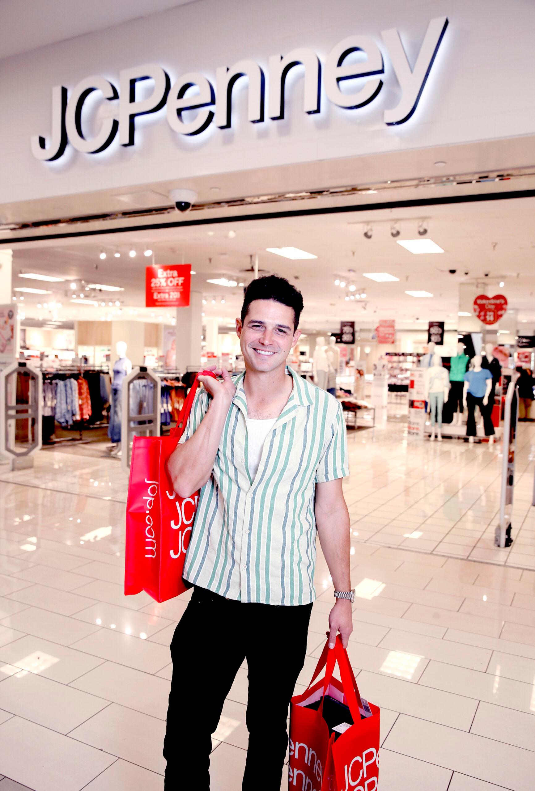 Wells Adams holding shopping bags in JCPenney