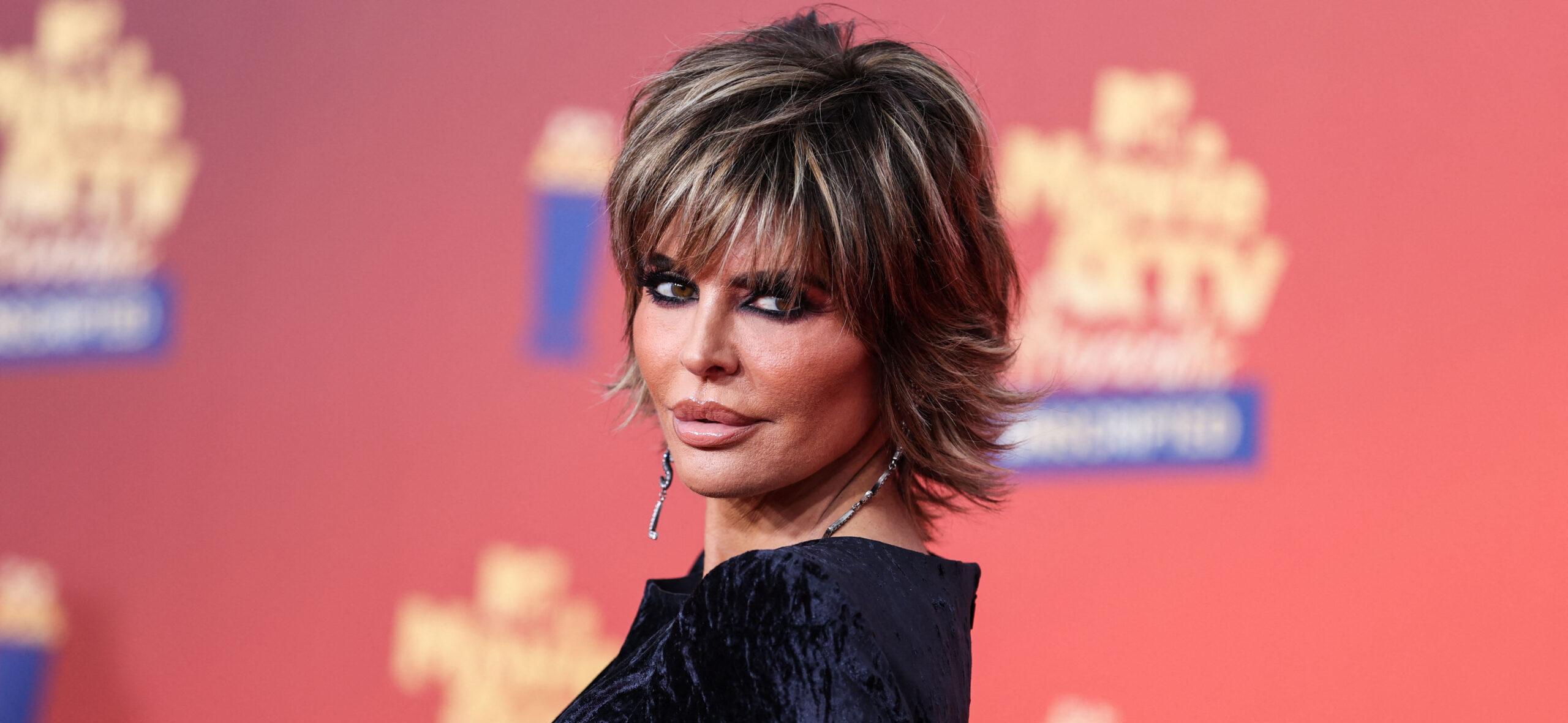 Lisa Rinna posing in a black dress during the MTV Movie Awards.