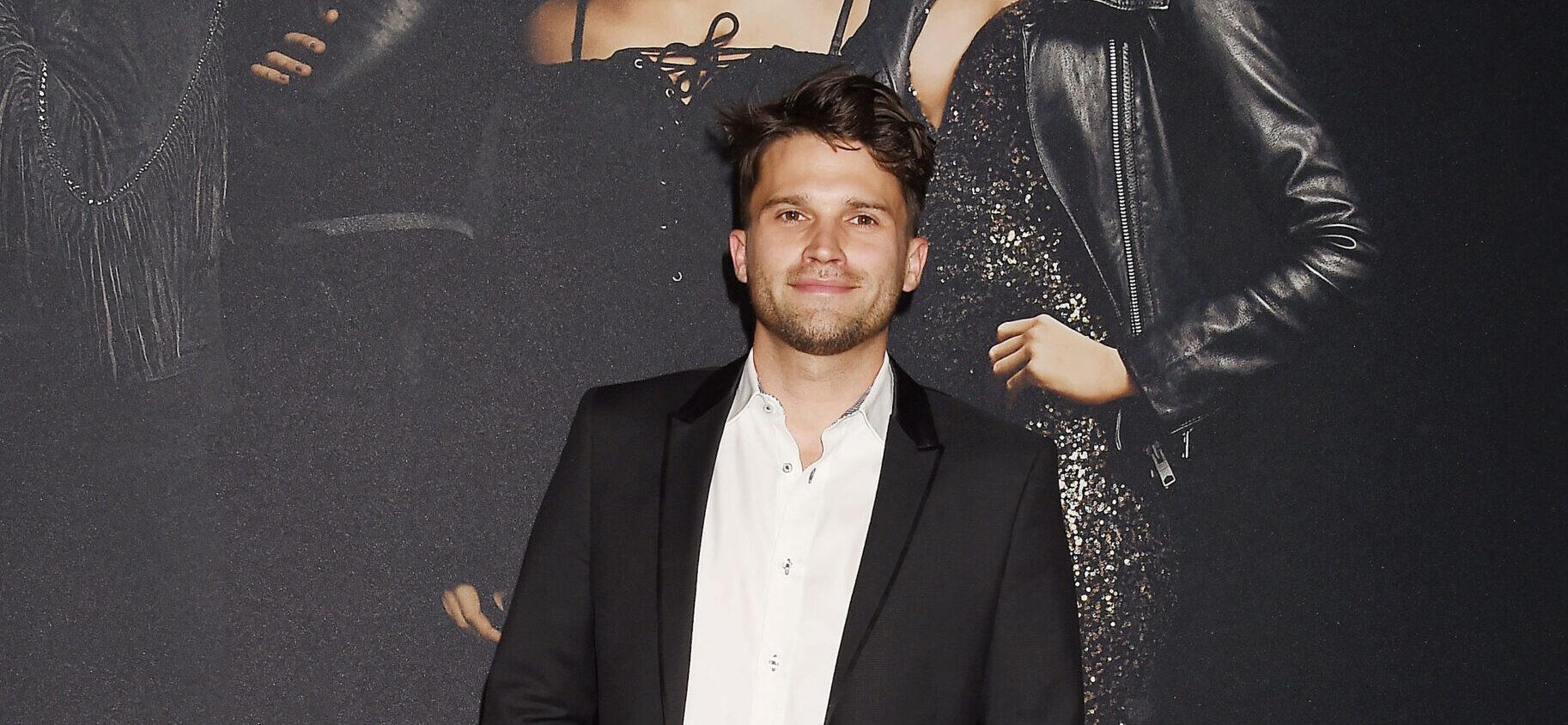 Tom Schwartz posing in a black jacket and white shirt