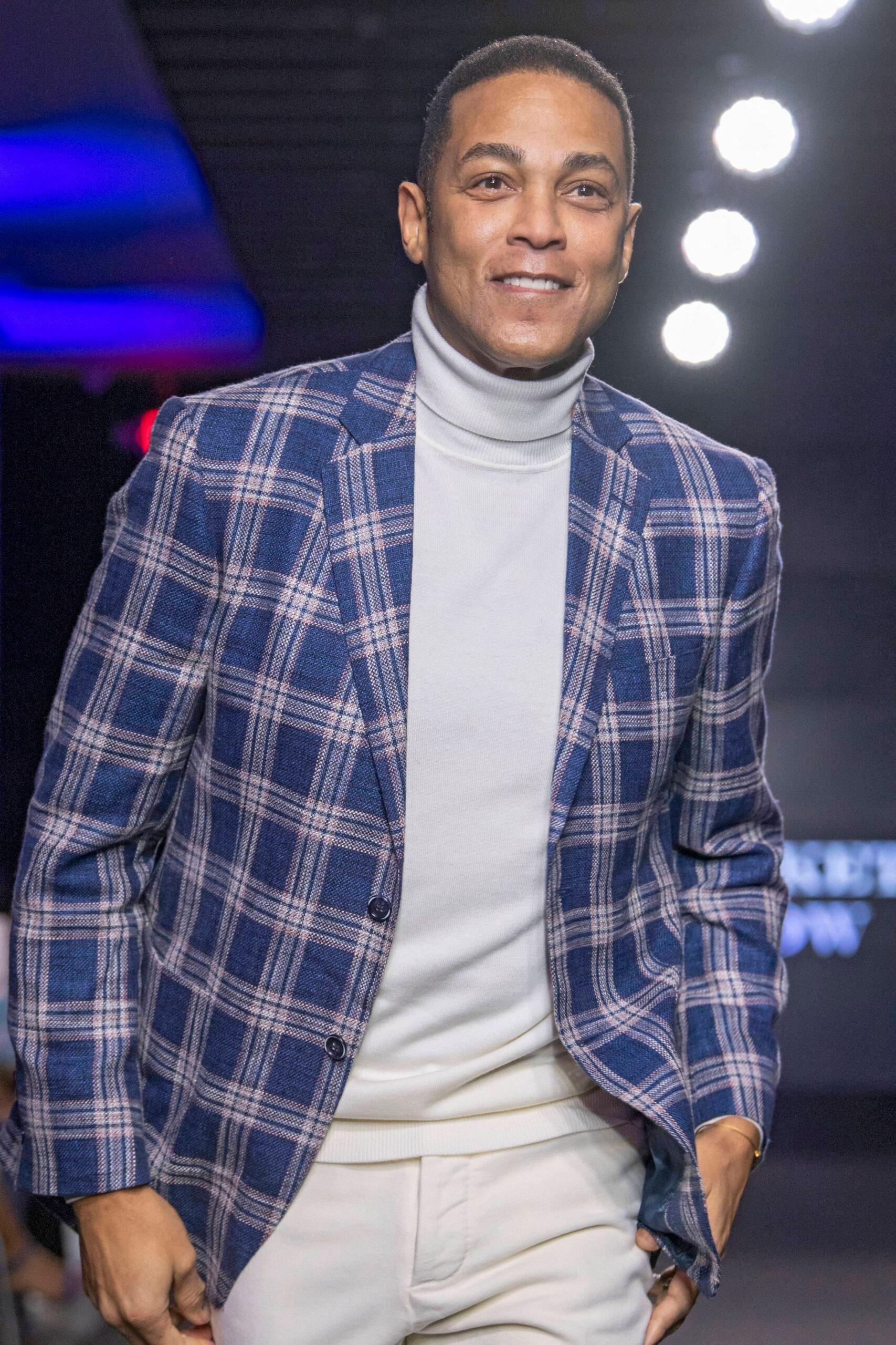 Don Lemon in a blue suit jacket smiling. 