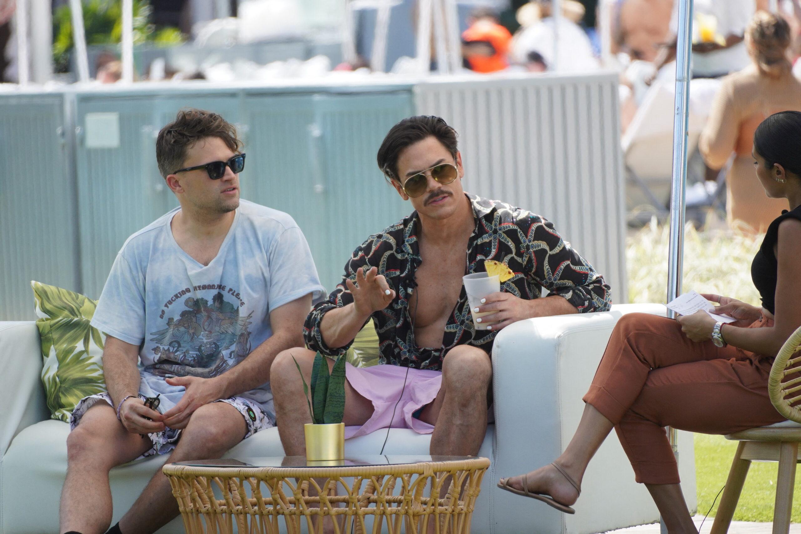 Picture of Tom Sandoval and Tom Schwartz sitting on a couch together speaking to someone. 