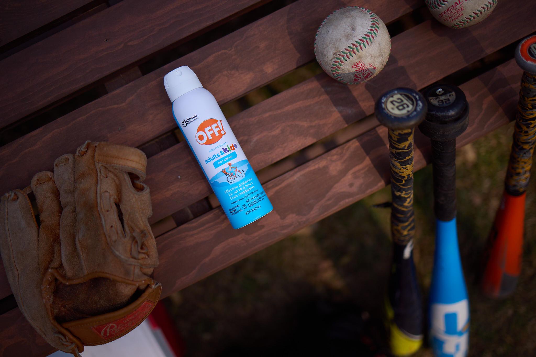 OFF spray on a table with baseball gear