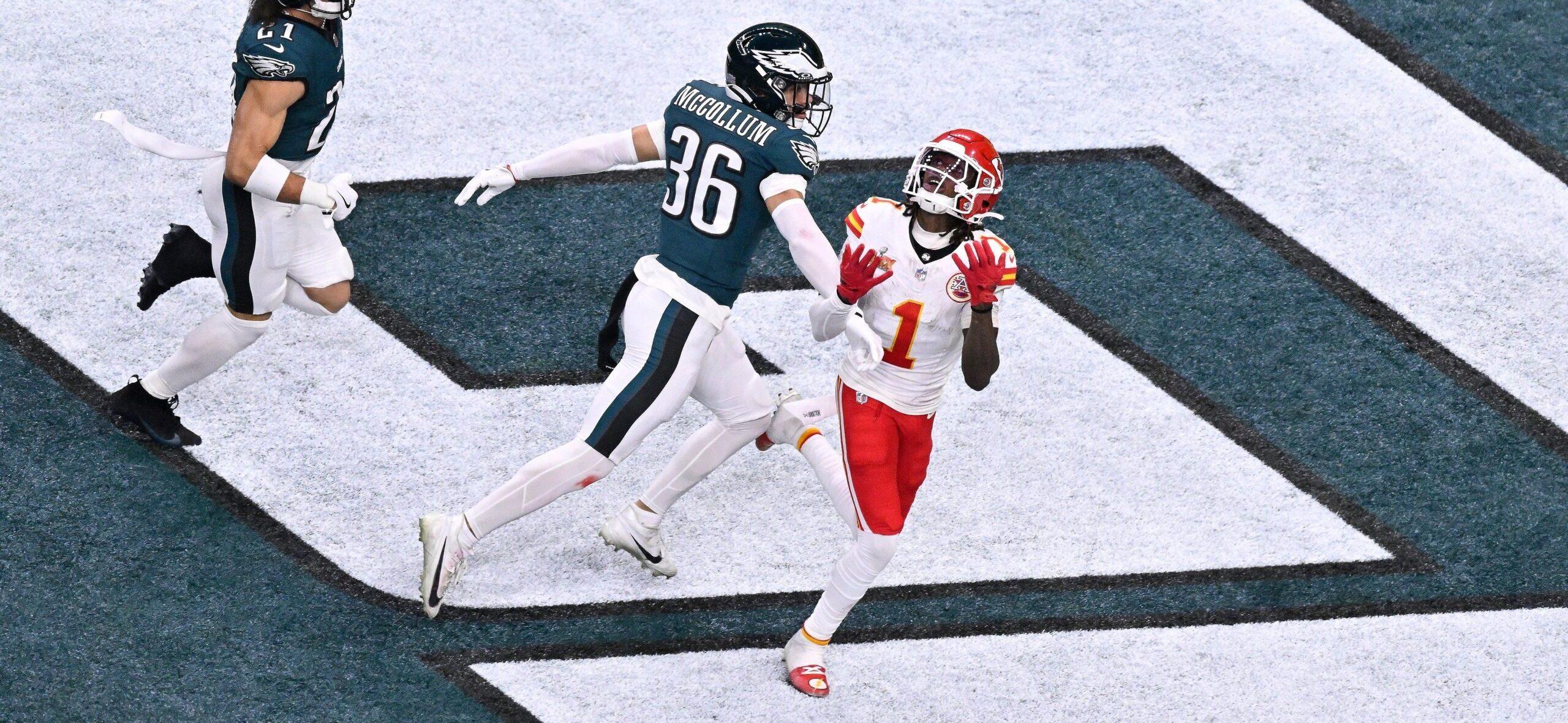 Xavier Worthy catching a football during an NFL game.