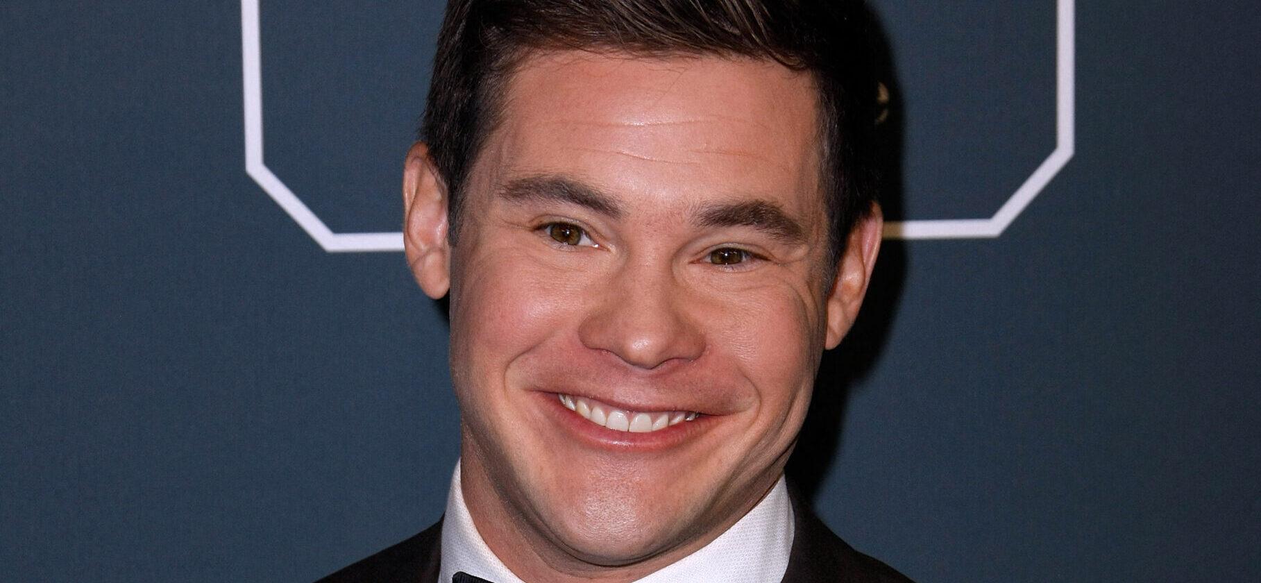 Adam DeVine posing on the red carpet.