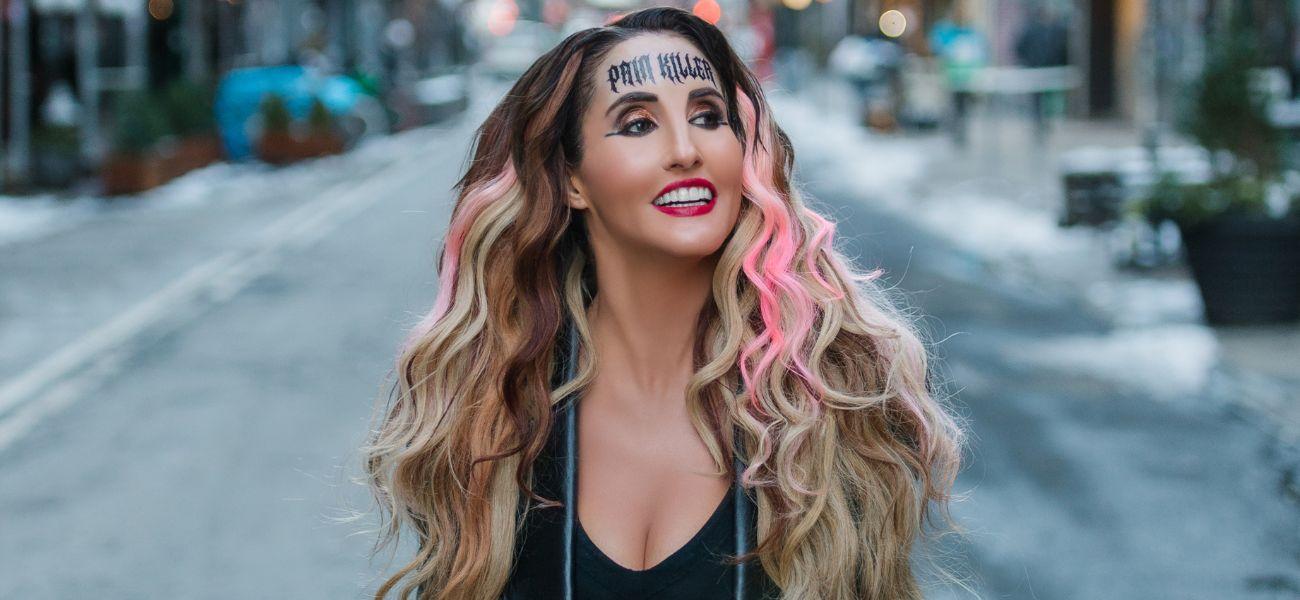 Laura Bryna Drops Emotional New Track ‘PAINKILLER,’ And It’s Written All Over Her Face, Literally