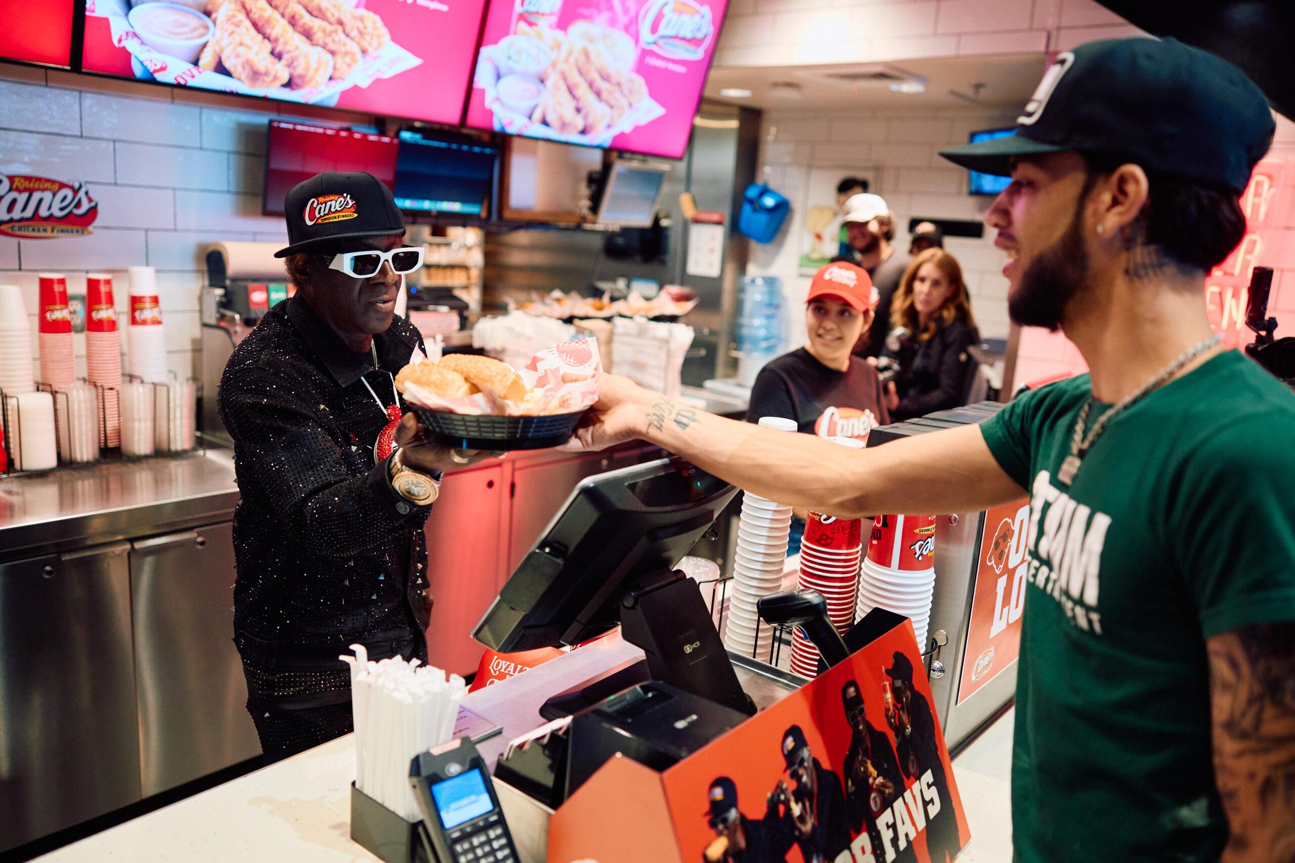 Flavor Flav serving customers at Raising Cane's
