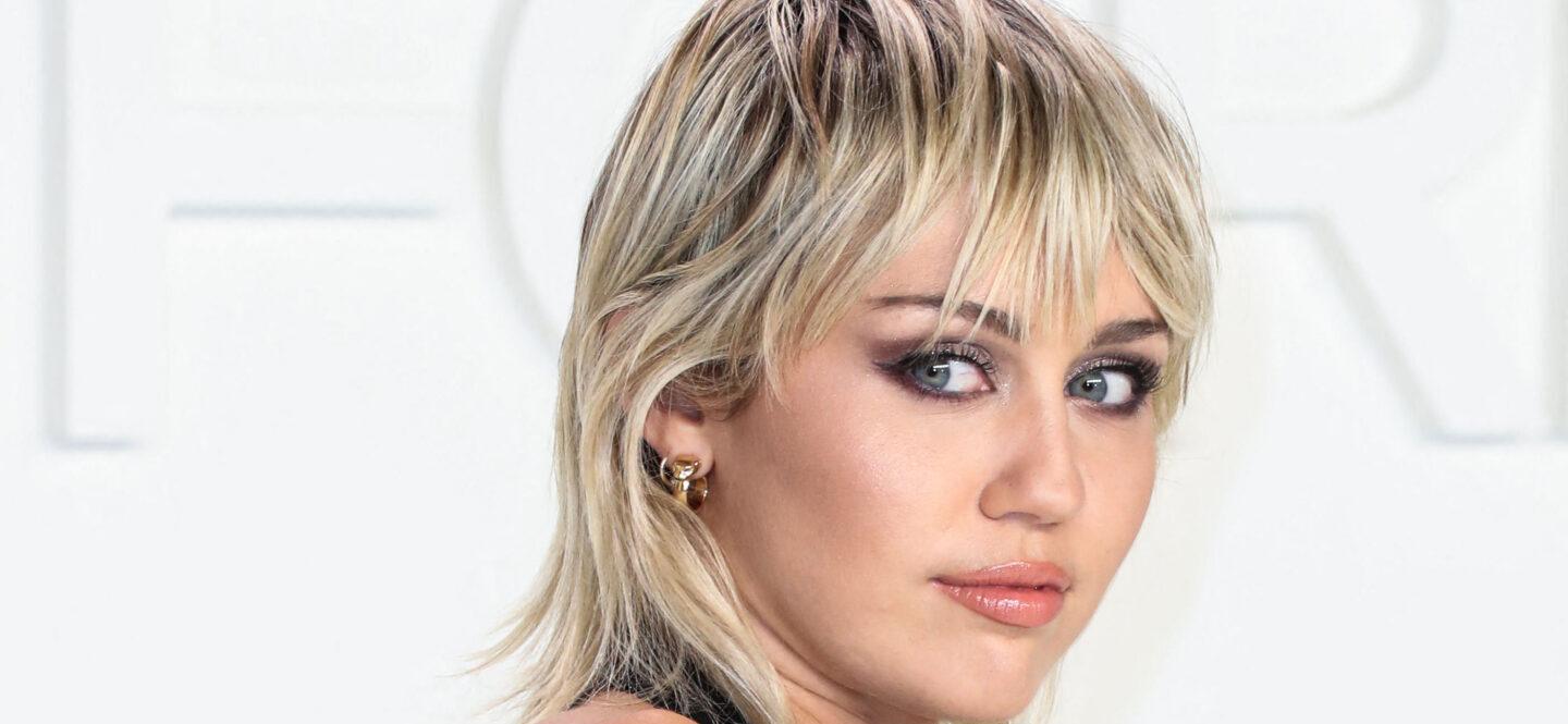 Miley Cyrus poses in black outfit