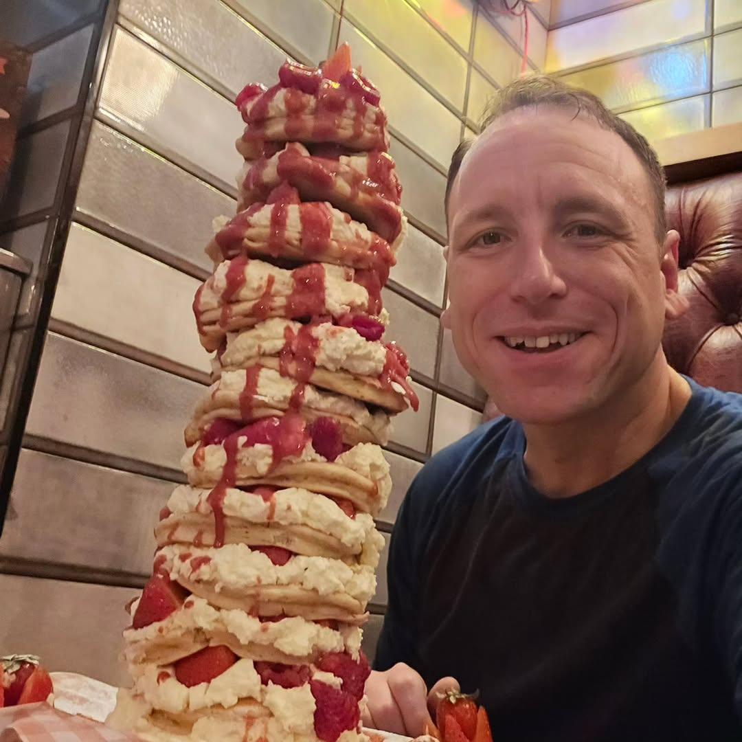 Joey Chestnut next to tower of waffles