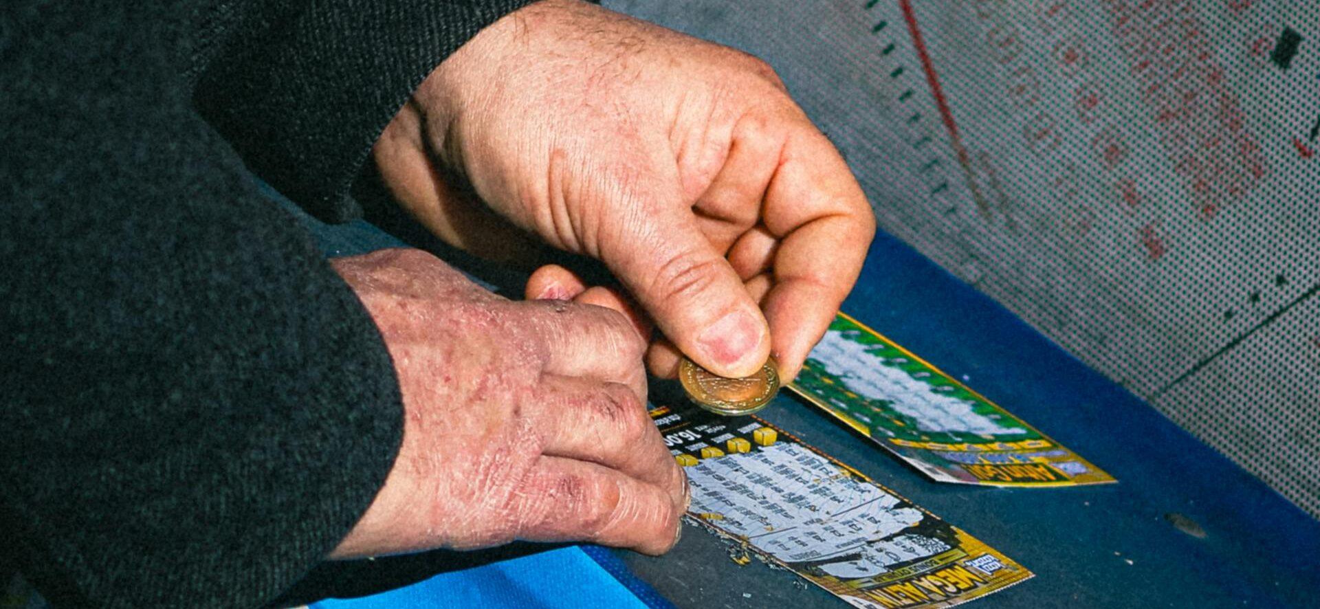 A man scratching a lottery ticket