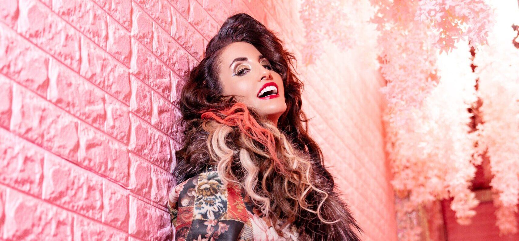 Laura Bryna leaning against a wall