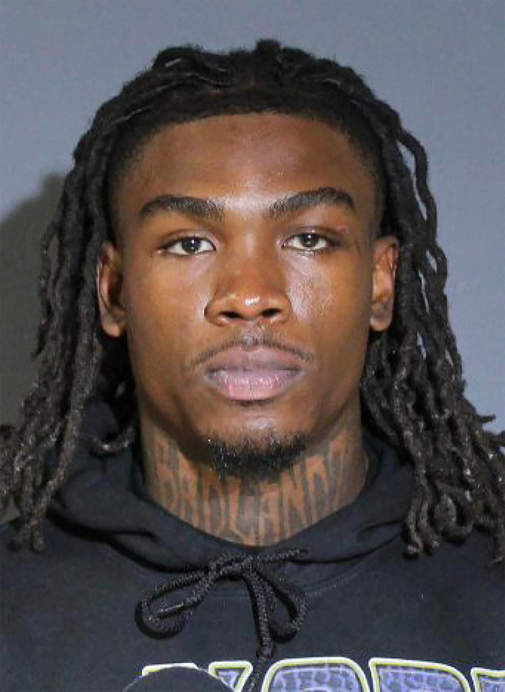 Rashee Rice is stoic in his mugshot after turning himself in to Dallas PD over six car crash.