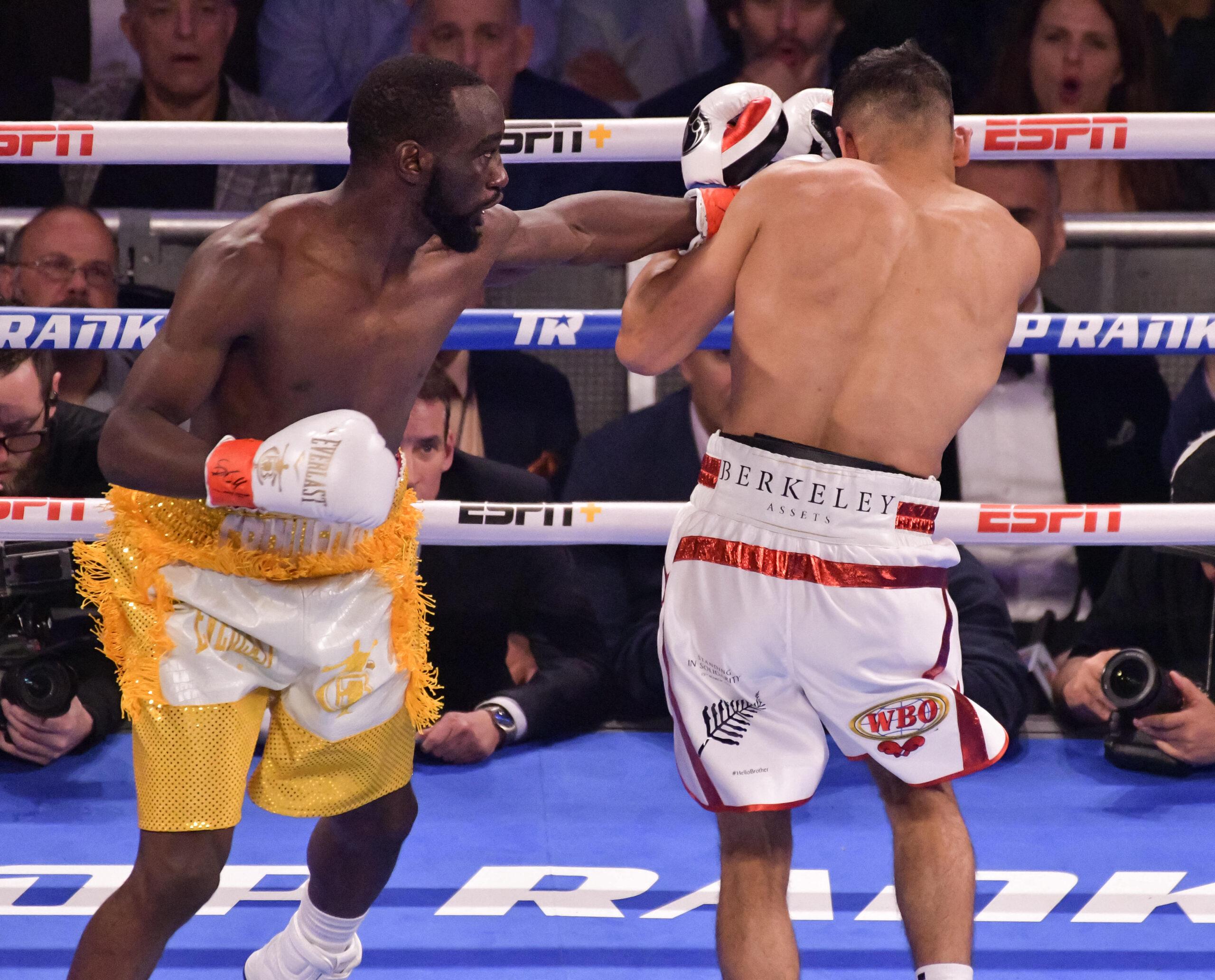 TERENCE CRAWFORD (yellow trunks) and AMIR KHAN battle in a WBO welterweight world championship bout at Madison Square Garden in New York, New York. 21 Apr 2019 