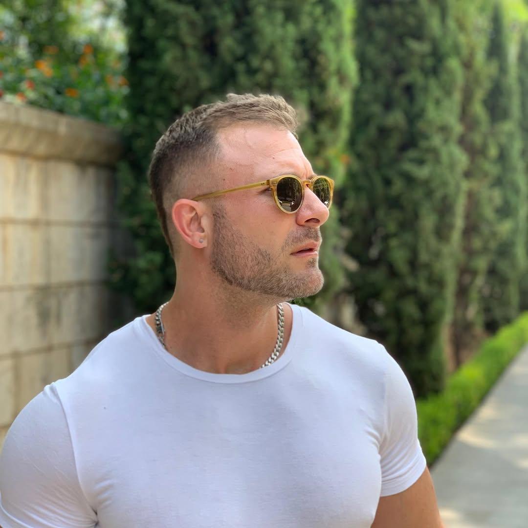 Austin Wolf posing outside. 