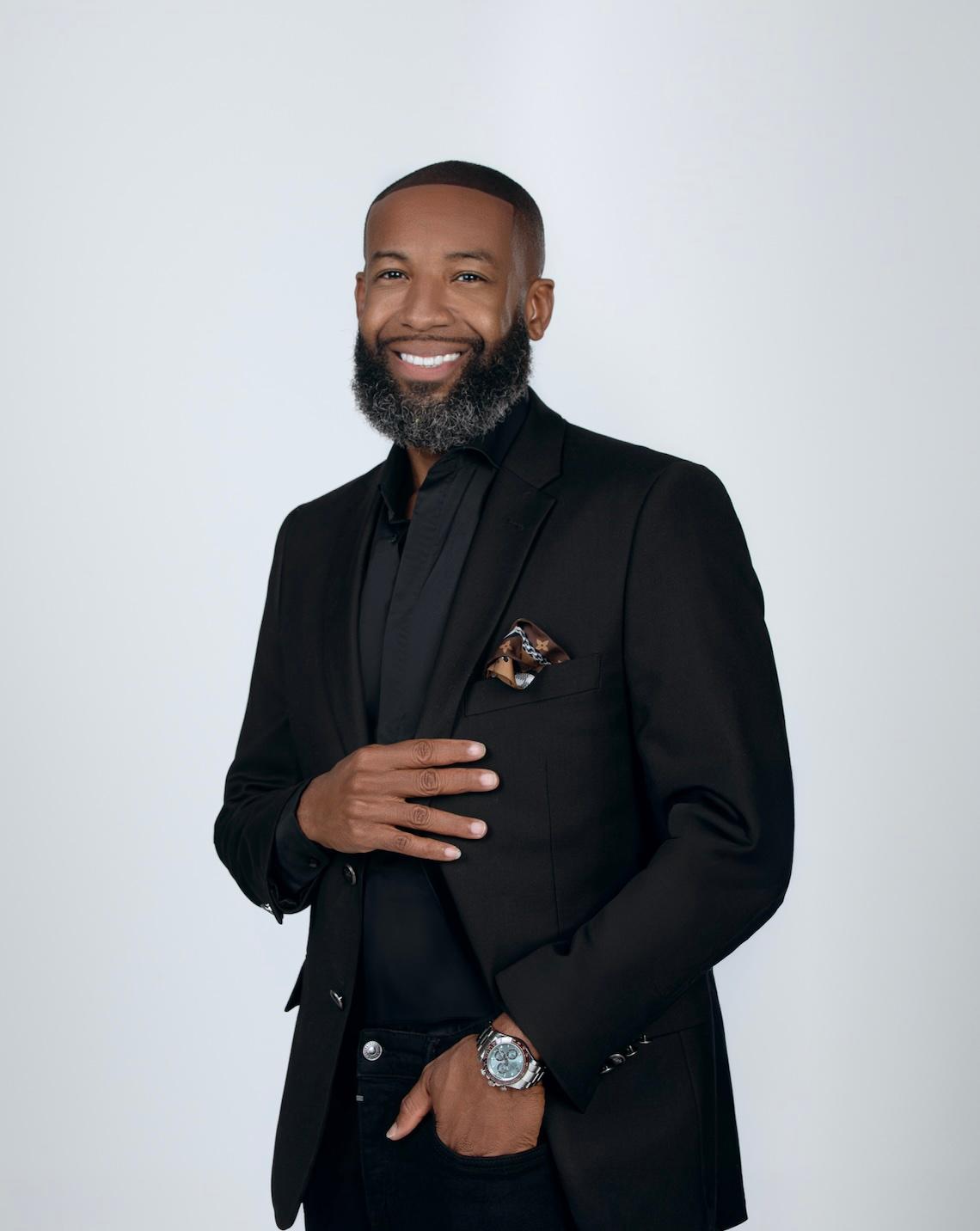 Carlos King in black suit