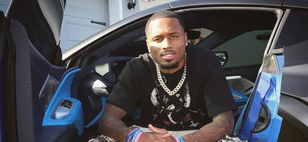 Isaiah Rodgers posing for a picture inside of a car.