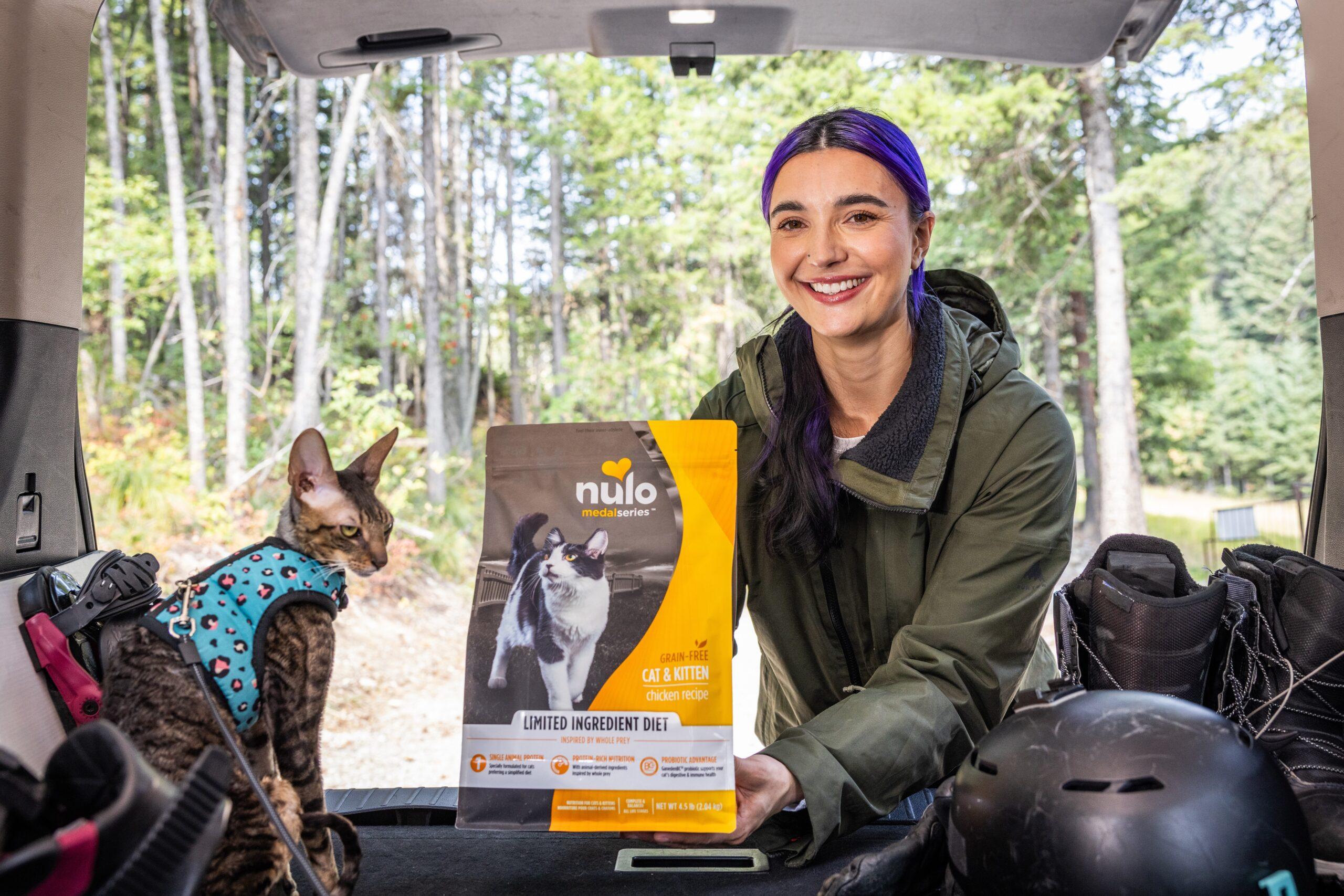 Brenna Huckaby feeding her cat Nulo