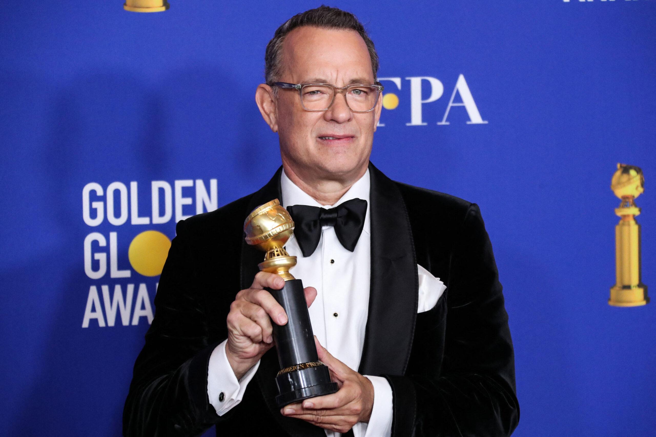 Tom Hanks holding a Golden Globe