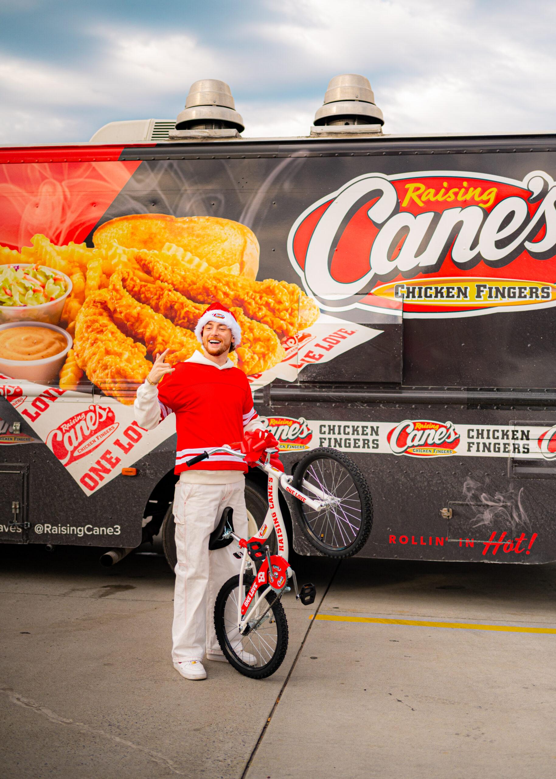 Bailey Zimmerman at Raising Cane's event for bike giveaway