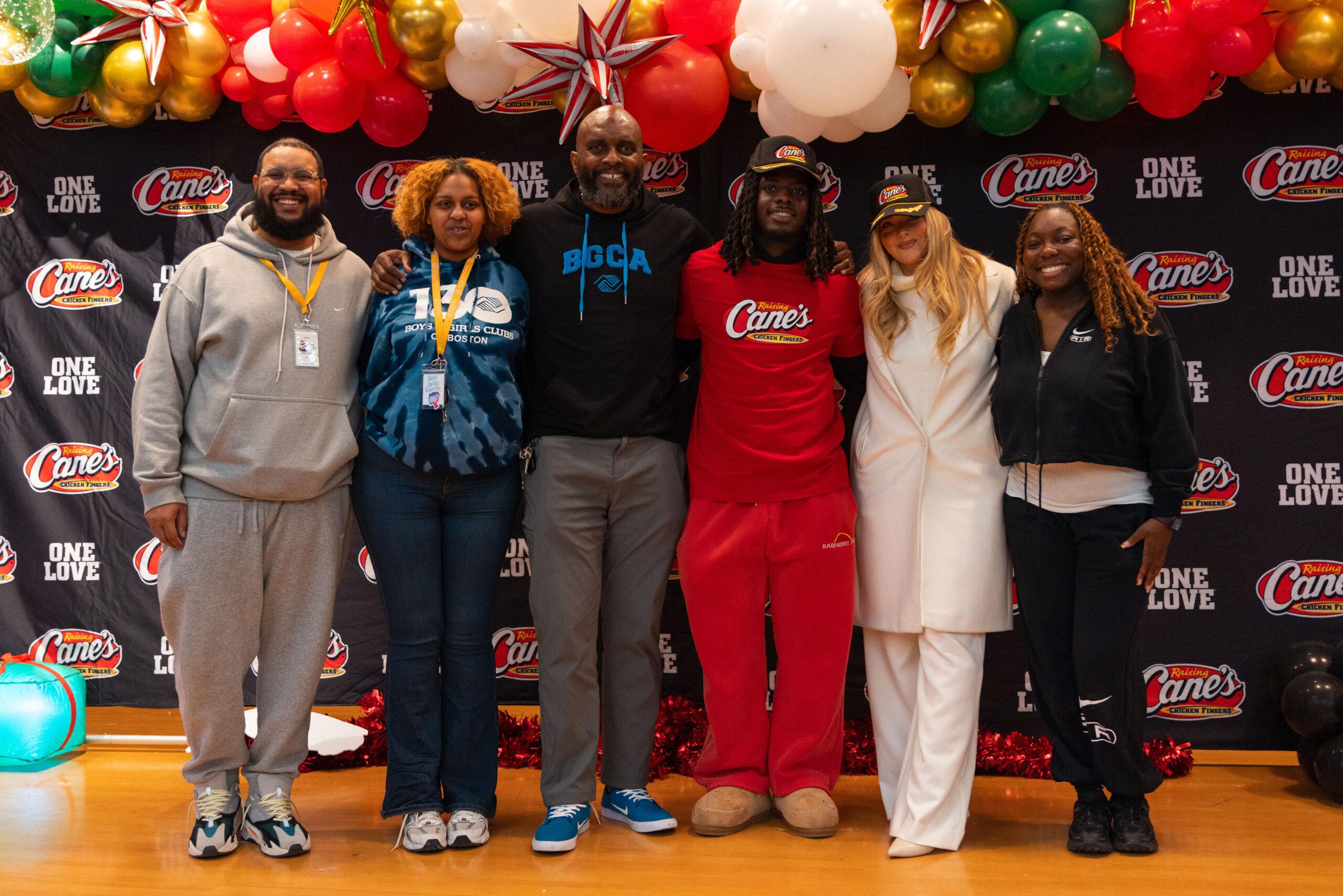 Camille Kostek, D'Ernest Johnson and Raising Cane's members at charity event