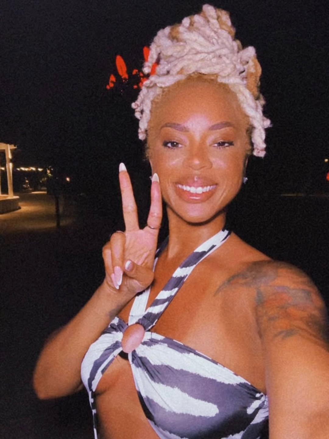 Mickey Lee holds up the peace sign