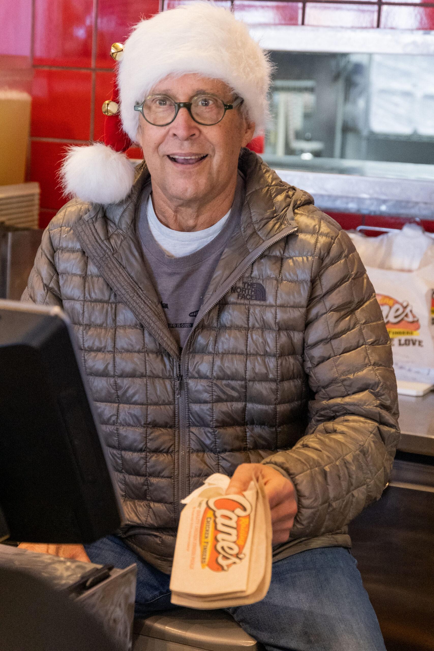 Chevy Chase surprises Raising Canes diners by serving orders at the drive-thru and counter