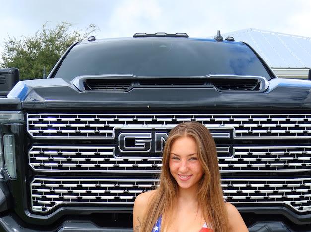 Anya Lacey standing in front of a car