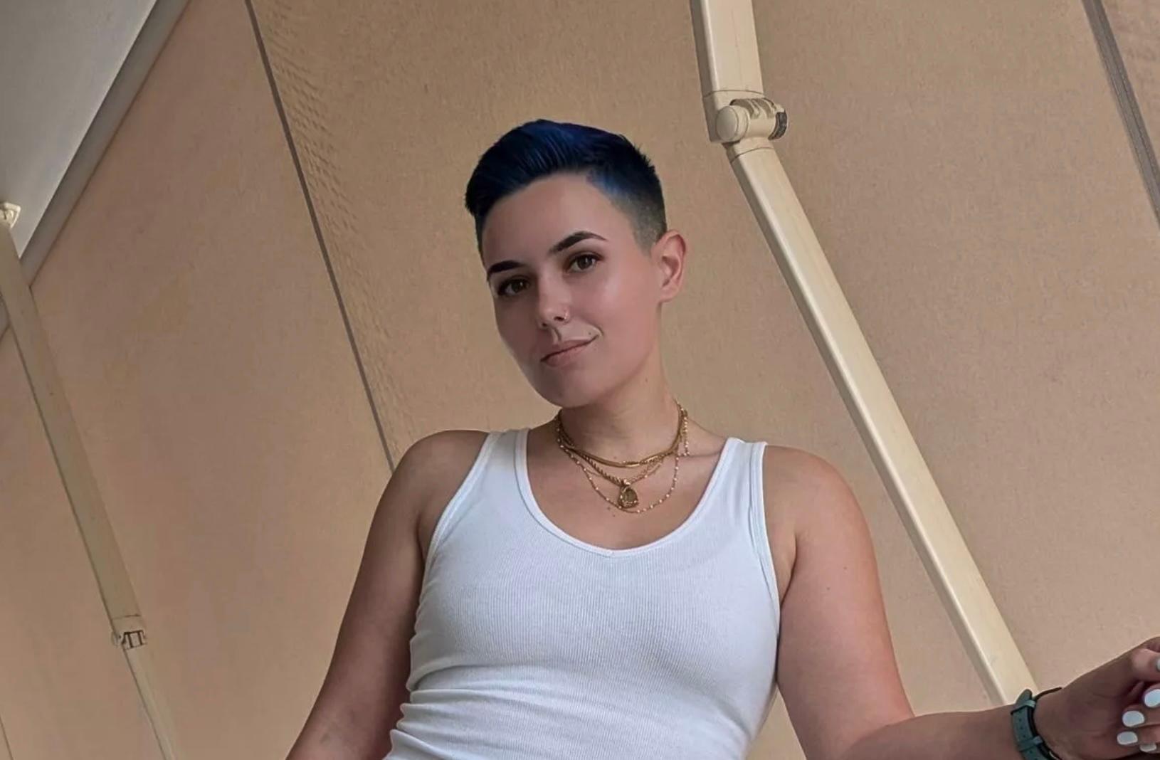 Kit Barrus wearing a white tank top