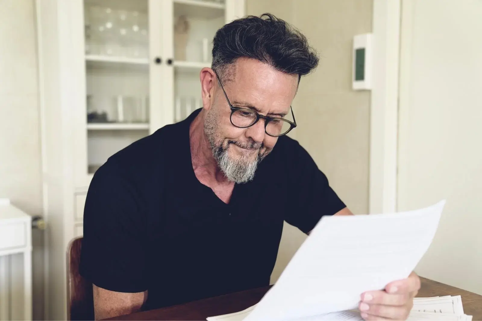 Andy Martin looking at a piece of paper smiling