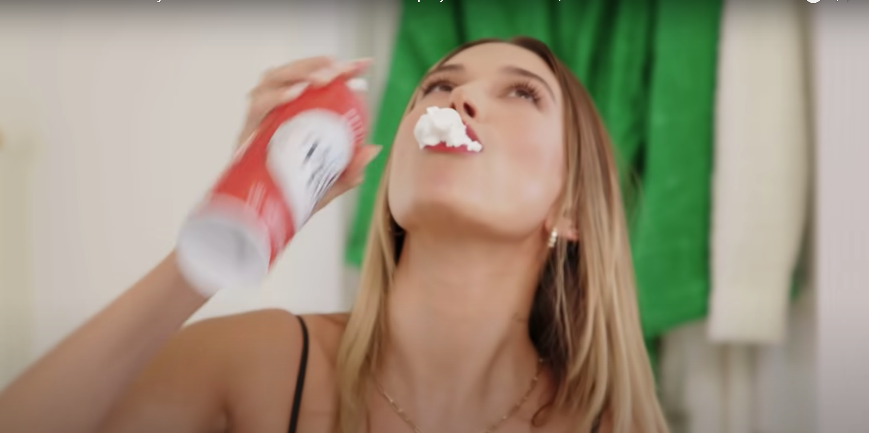 Hailey Bieber with whipped cream in her mouth