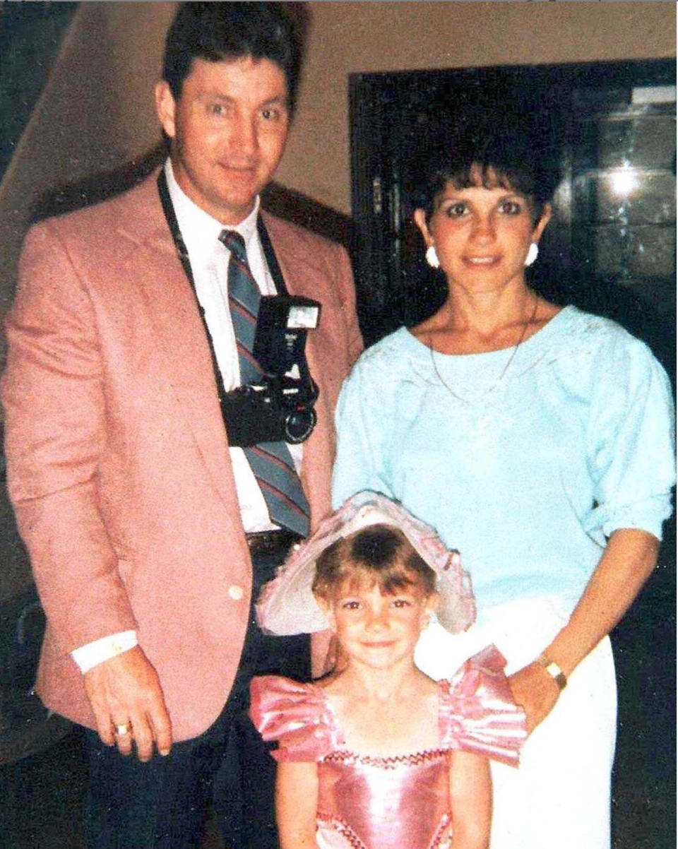 Britney Spears as a young girl in a pink dance outfit with her parents