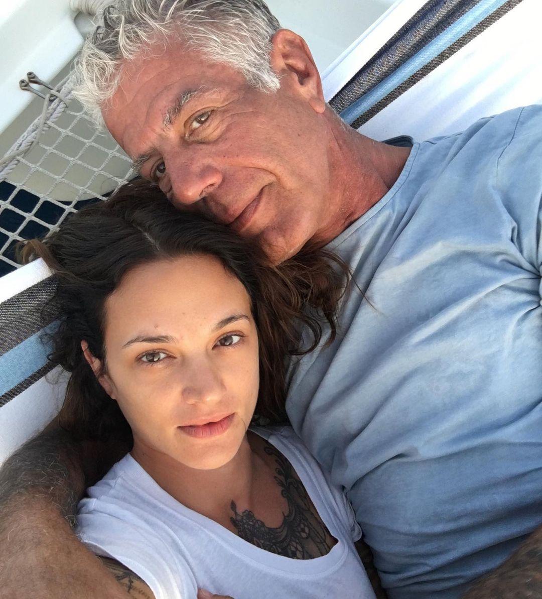 Asia Argento and Anthony Bourdain posing for a selfie.