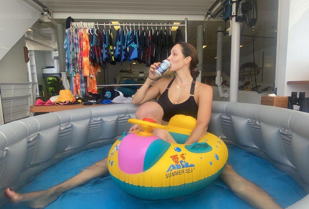 Katharine McPhee Foster drinking a beer in a kiddy pool