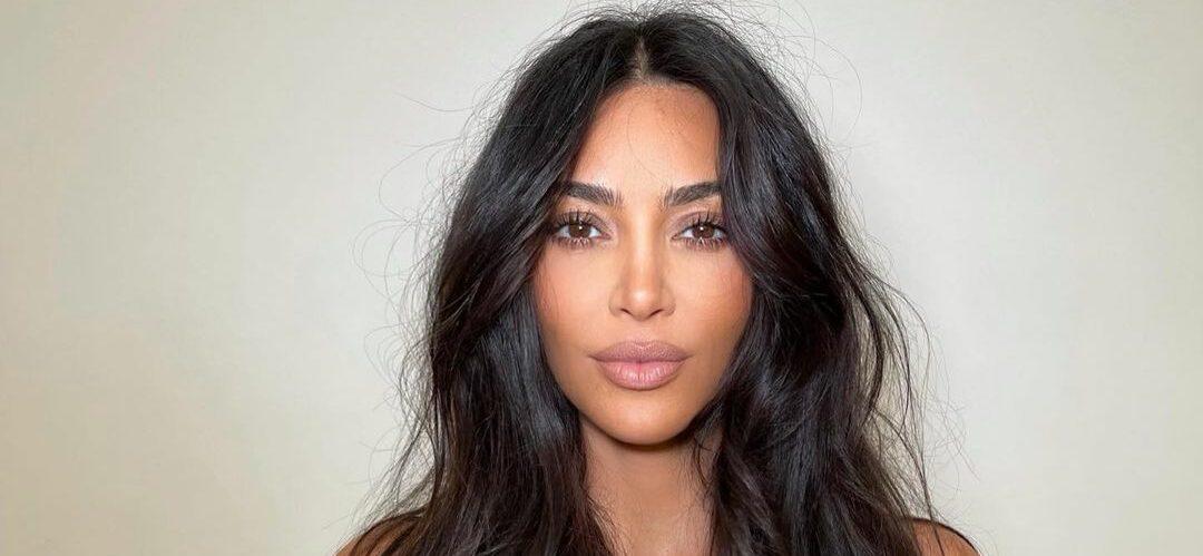 Kim Kardashian pursing her lips with messy hair