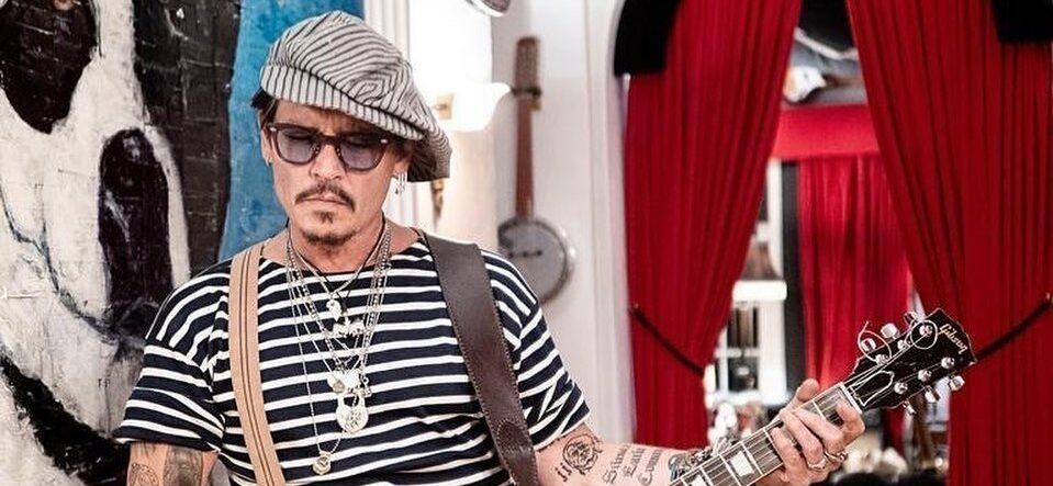A photo of Johnny Depp holding a guitar