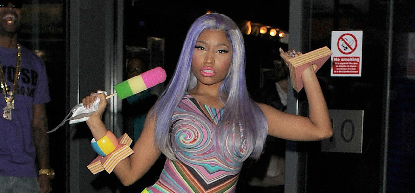 Nicki Minaj leaving the W Hotel in Leicester Square The singer showed off her new blue hair and wore a multicoloured top neon yellow hot pants tights and neon yellow boots