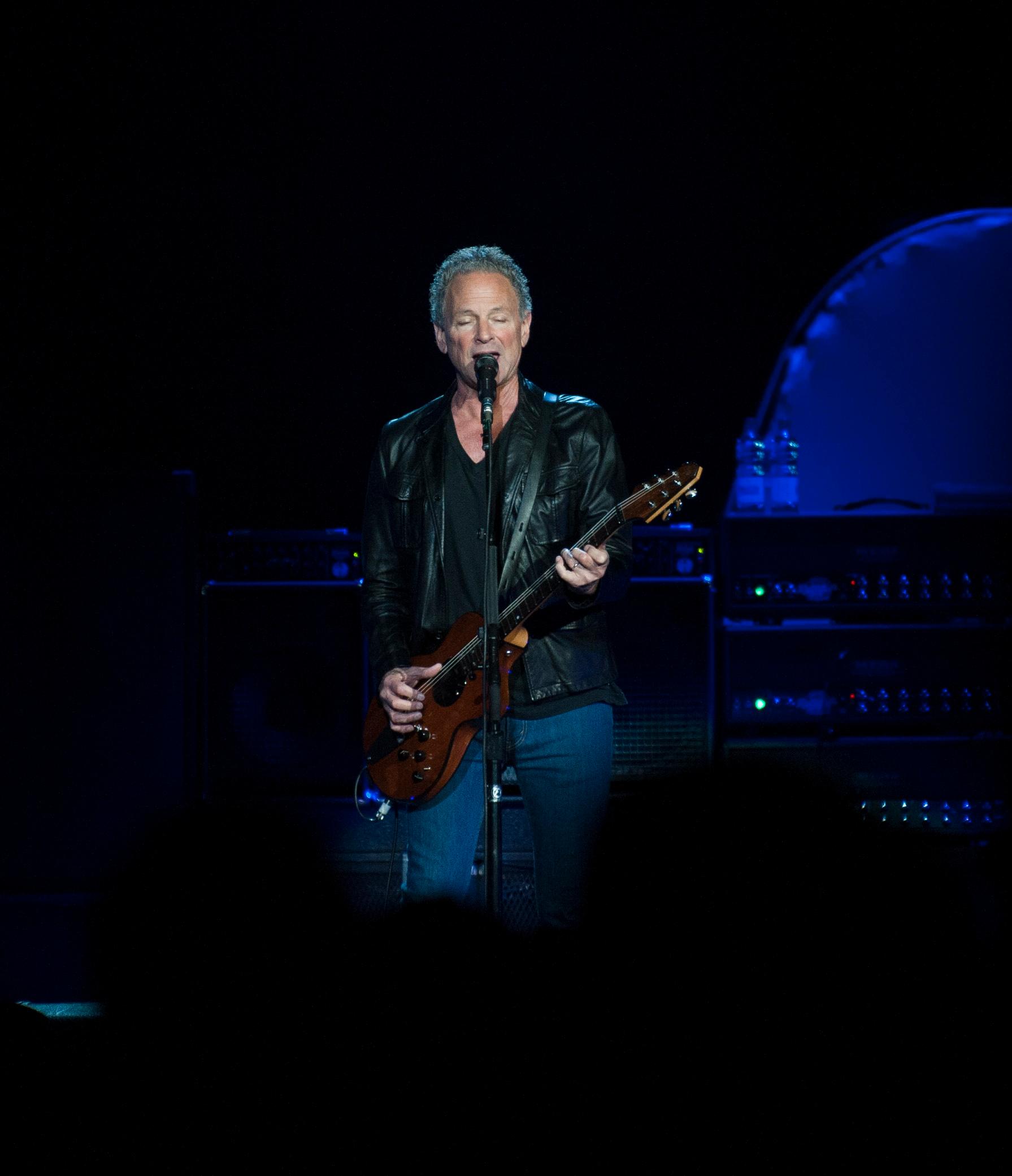 Fleetwood Mac performing at the Phones 4u Arena, Manchester, England on 1st October 2013. Singer / guitarist Lindsey Buckingham.