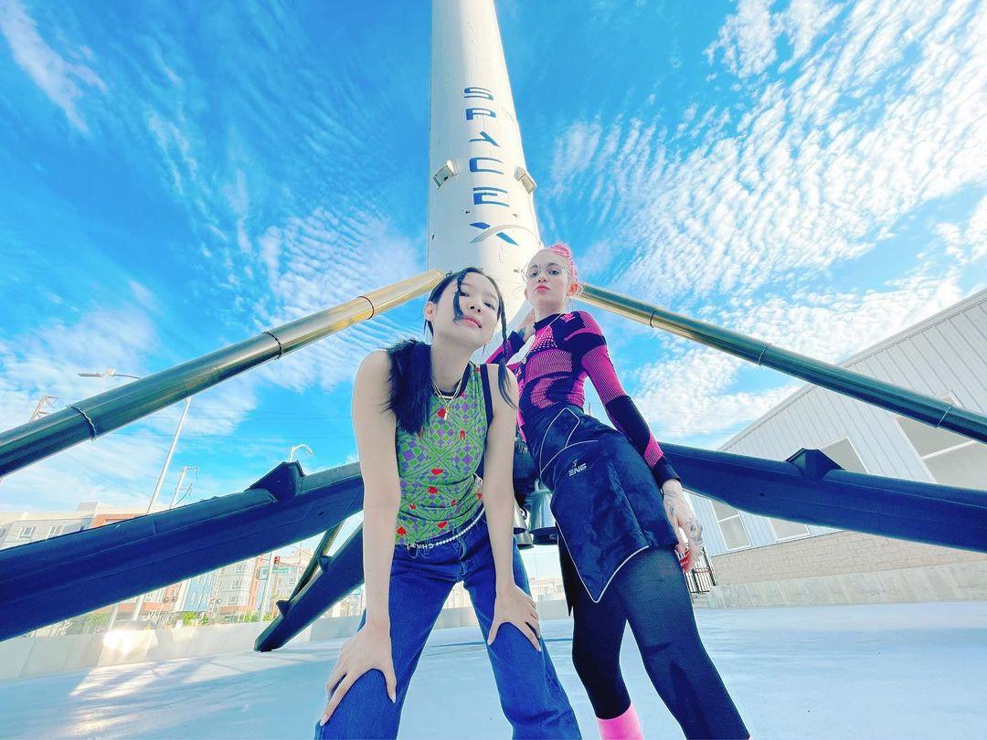 Grimes posing in front of a SpaceX rocket.
